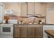 White appliances and a mosaic backsplash highlight this kitchen at 2311 Brevard Ne Rd, St Petersburg, FL 33704