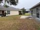 Backyard view showcasing a patio area and neighboring houses at 6554 Gentle Ben Cir, Wesley Chapel, FL 33544