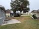 Spacious backyard with a patio and lush green grass at 6554 Gentle Ben Cir, Wesley Chapel, FL 33544