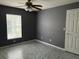 Bedroom with gray walls, tile floors and ceiling fan at 6554 Gentle Ben Cir, Wesley Chapel, FL 33544