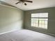 Well-lit bedroom with neutral walls and carpet flooring at 6554 Gentle Ben Cir, Wesley Chapel, FL 33544