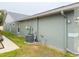 Side view of the house showing exterior and AC unit at 6554 Gentle Ben Cir, Wesley Chapel, FL 33544