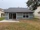 House exterior showcasing the back of the house with a sliding glass door and patio at 6554 Gentle Ben Cir, Wesley Chapel, FL 33544