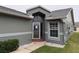 Gray house exterior featuring the front entrance and walkway at 6554 Gentle Ben Cir, Wesley Chapel, FL 33544