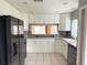 Kitchen with white cabinets, stainless steel appliances, and gray countertops at 6554 Gentle Ben Cir, Wesley Chapel, FL 33544