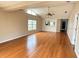 Bright living room with hardwood floors and a view to the kitchen at 6554 Gentle Ben Cir, Wesley Chapel, FL 33544