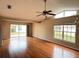 Spacious living room featuring hardwood floors, high ceilings, and large windows at 6554 Gentle Ben Cir, Wesley Chapel, FL 33544