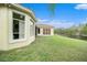Landscaped backyard with water view, showcasing home's exterior at 8478 Dunham Station Dr, Tampa, FL 33647