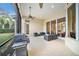Screened lanai with seating area and outdoor grill at 8478 Dunham Station Dr, Tampa, FL 33647