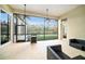 Relaxing screened patio with grill and outdoor furniture, overlooking tranquil water views at 8478 Dunham Station Dr, Tampa, FL 33647