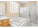 Bathroom with a large soaking tub and separate shower at 18214 Stillwell Ln, Tampa, FL 33647