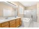 Spacious bathroom with double vanity, soaking tub, and separate shower at 18214 Stillwell Ln, Tampa, FL 33647