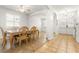 Dining room with tiled floor, wood table and chairs, and access to kitchen at 18214 Stillwell Ln, Tampa, FL 33647