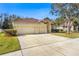 Two-story house with a three-car garage and neatly landscaped yard at 18214 Stillwell Ln, Tampa, FL 33647