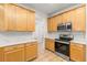 Modern kitchen with stainless steel appliances and white countertops at 18214 Stillwell Ln, Tampa, FL 33647