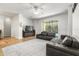 Living room with leather sectional sofa and access to the pool at 18214 Stillwell Ln, Tampa, FL 33647