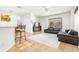 Living room with black leather sofa, access to pool, and large window at 18214 Stillwell Ln, Tampa, FL 33647