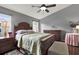 Main bedroom features a wood bed frame and ceiling fan at 22247 Red Jacket Ln, Land O Lakes, FL 34639