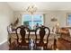 Bright dining room with hardwood floors, a large table, and a chandelier at 22247 Red Jacket Ln, Land O Lakes, FL 34639