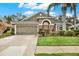 Attractive single-story house with a two-car garage and well-manicured lawn at 22247 Red Jacket Ln, Land O Lakes, FL 34639