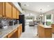 Kitchen with island, granite countertops, and view into Gathering room at 22247 Red Jacket Ln, Land O Lakes, FL 34639