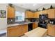Bright kitchen with granite countertops, wood cabinets, and stainless steel appliances at 22247 Red Jacket Ln, Land O Lakes, FL 34639