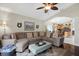 Living room with a sectional sofa, a large TV, and access to the backyard at 22247 Red Jacket Ln, Land O Lakes, FL 34639