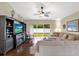 Spacious living room with a sectional sofa, built-in entertainment center, and backyard access at 22247 Red Jacket Ln, Land O Lakes, FL 34639