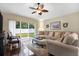 Comfortable living room with sectional sofa, ottoman, and sliding glass doors to the backyard at 22247 Red Jacket Ln, Land O Lakes, FL 34639