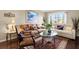 Spacious living room with hardwood floors, comfortable seating, and large windows at 22247 Red Jacket Ln, Land O Lakes, FL 34639