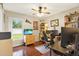 Home office with wood floors, built-in shelving, and two work stations at 22247 Red Jacket Ln, Land O Lakes, FL 34639