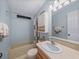 Clean bathroom with tub, shower, and updated vanity at 3907 William Hume Dr, Zephyrhills, FL 33541
