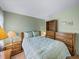 Comfortable bedroom with full bed and wood furniture at 3907 William Hume Dr, Zephyrhills, FL 33541