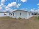 Light green manufactured home with a spacious yard at 3907 William Hume Dr, Zephyrhills, FL 33541