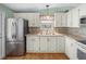 Modern kitchen with stainless steel appliances and white cabinets at 3907 William Hume Dr, Zephyrhills, FL 33541