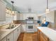 White kitchen with stainless steel appliances and a breakfast bar at 3907 William Hume Dr, Zephyrhills, FL 33541