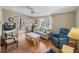 Bright living room with wood floors, comfy seating, and access to a screened porch at 3907 William Hume Dr, Zephyrhills, FL 33541
