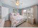 Main bedroom with king-size bed and light blue walls at 3907 William Hume Dr, Zephyrhills, FL 33541