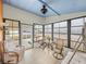 Relaxing sunroom with seating, table, and ceiling fan at 3907 William Hume Dr, Zephyrhills, FL 33541