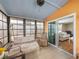 Bright sunroom features a swing, comfy seating, and access to the living area at 3907 William Hume Dr, Zephyrhills, FL 33541