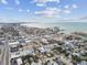 Aerial view of coastal town with beachfront, residential homes, and businesses at 440 77Th Ave, St Pete Beach, FL 33706