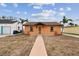 Charming bungalow-style house with a walkway leading to the front door at 440 77Th Ave, St Pete Beach, FL 33706