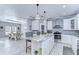 Spacious kitchen featuring granite countertops, stainless steel appliances, and white cabinetry at 4424 Tevalo Dr, Valrico, FL 33596