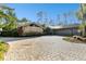 House exterior with stone accents and a circular driveway at 5474 Kemkerry Rd, Wesley Chapel, FL 33543