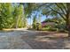 Landscaped driveway leading to a house with stone exterior at 5474 Kemkerry Rd, Wesley Chapel, FL 33543