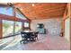 Gathering room with brick wall, high ceilings and large windows at 5474 Kemkerry Rd, Wesley Chapel, FL 33543