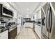 Modern kitchen with stainless steel appliances and granite countertops at 5474 Kemkerry Rd, Wesley Chapel, FL 33543