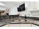 Modern kitchen features granite countertops and stainless steel sink at 5474 Kemkerry Rd, Wesley Chapel, FL 33543