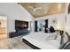 Bright main bedroom with large TV and sliding glass doors at 5474 Kemkerry Rd, Wesley Chapel, FL 33543