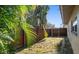 Private backyard with wooden fence and small grassy area at 587 Hillcrest Dr, Largo, FL 33771
